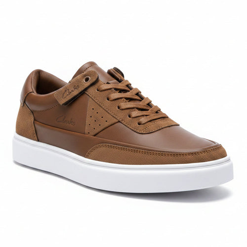 Brown sneakers with white soles on a beige box against a light background