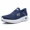 Blue sneakers with white soles on a textured surface with a blurred green background