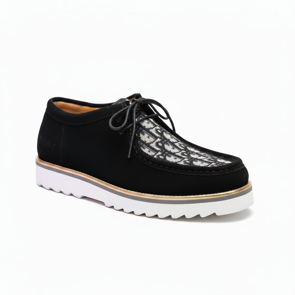 Black leather shoes with white soles on a metal surface