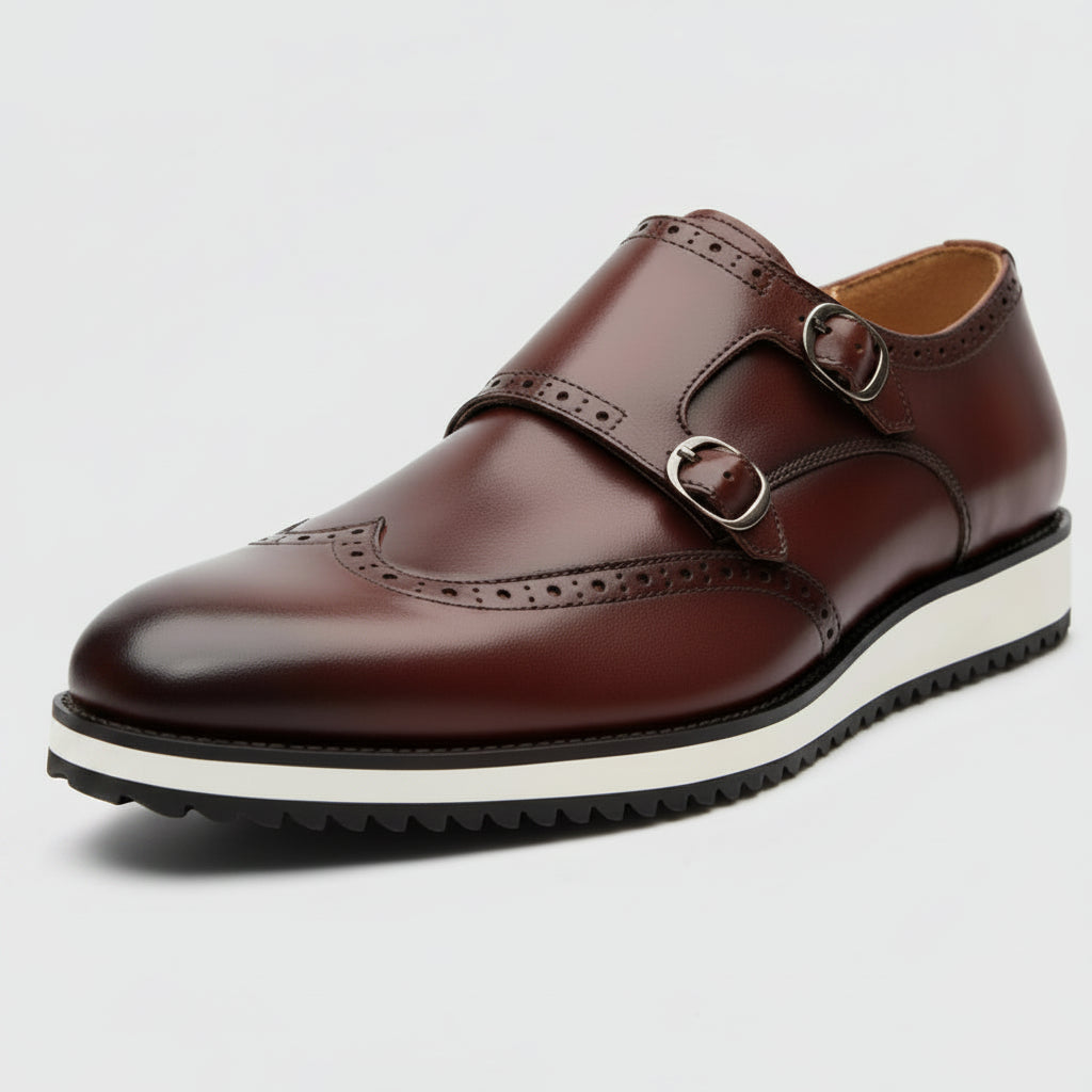 Brown leather shoe with a white sole on a light gray background